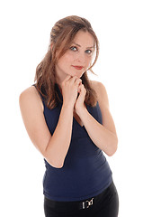 Image showing Woman standing with her hands under her chin