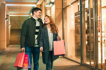 Image showing The happy couple with shopping bags enjoying night at city background