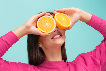 Image showing Beautiful woman\'s face with juicy orange