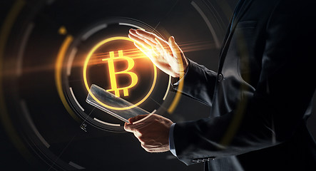 Image showing businessman with tablet pc and bitcoin hologram