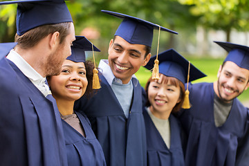 Image showing happy students or bachelors in mortar boards