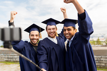 Image showing happy male students or graduates taking selfie