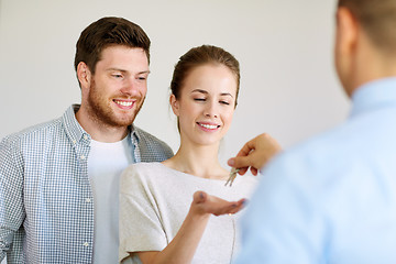 Image showing realtor giving keys from new home to happy couple