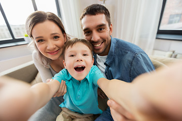 Image showing happy family taking selfie at home