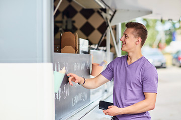 Image showing male customer with wallet at food truck