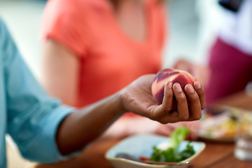 Image showing male hand holding peach