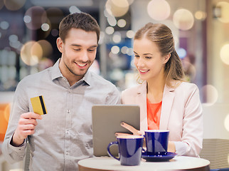 Image showing couple with tablet pc and credit card in mall