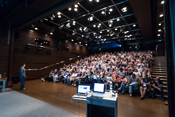 Image showing Business speaker giving a talk in conference hall.