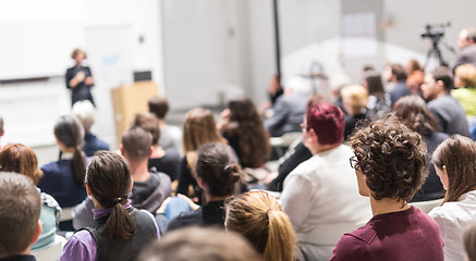 Image showing Woman giving presentation in lecture hall at university.