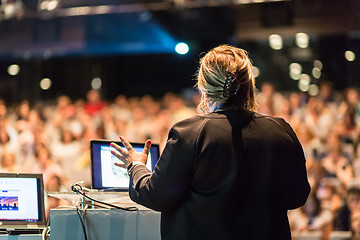 Image showing Female public speaker giving talk at Business Event.