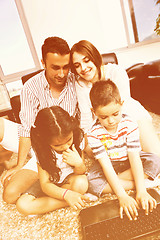 Image showing happy young family have fun and working on laptop at home