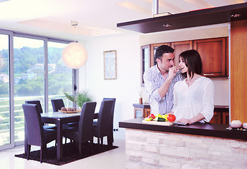 Image showing happy young couple have fun in modern kitchen