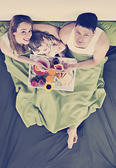 Image showing happy young family eat breakfast in bed