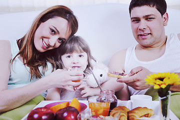 Image showing happy young family eat breakfast in bed