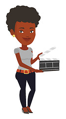 Image showing Smiling woman holding an open clapperboard.