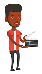 Image showing Smiling man holding an open clapperboard.