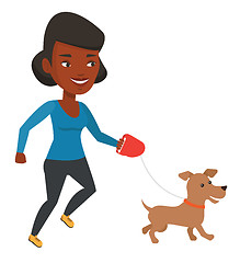 Image showing Young woman walking with her dog.