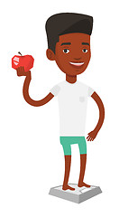 Image showing Man standing on scale and holding apple in hand.