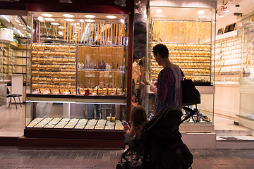 Image showing mother with  little girl in a stroller in front of  jewelry shop