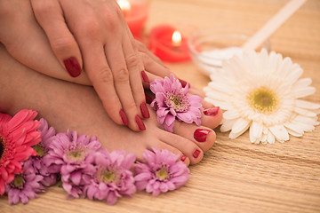 Image showing female feet and hands at spa salon