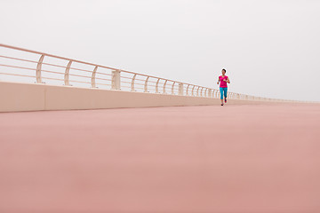 Image showing woman busy running on the promenade