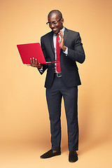 Image showing Handsome Afro American man sitting and using a laptop