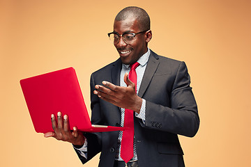 Image showing Handsome Afro American man sitting and using a laptop