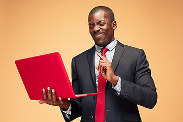 Image showing Handsome Afro American man sitting and using a laptop