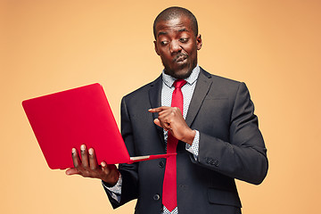 Image showing Handsome Afro American man sitting and using a laptop