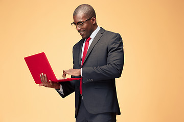 Image showing Handsome Afro American man using a laptop