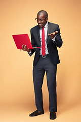 Image showing Handsome Afro American man using a laptop