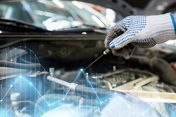 Image showing mechanic with dipstick checking motor oil level