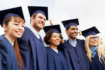 Image showing happy students or bachelors in mortar boards