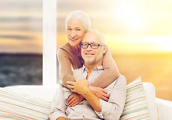 Image showing happy senior couple over sunset background