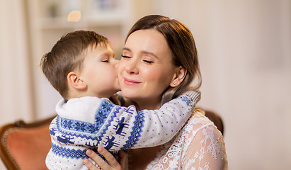 Image showing happy little son kissing his mother