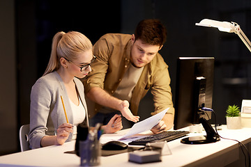 Image showing business team with papers working late at office