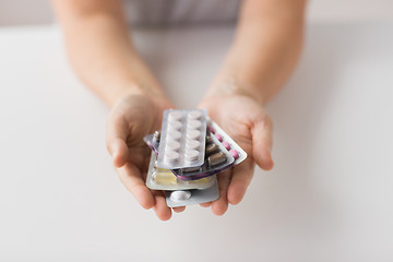Image showing woman hands holding packs of pills
