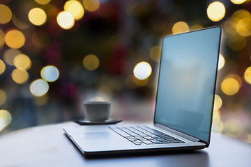 Image showing laptop and coffee cup on table at christmas