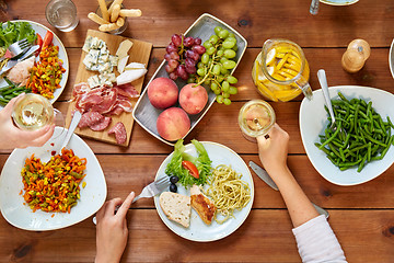 Image showing group of people eating at table with food