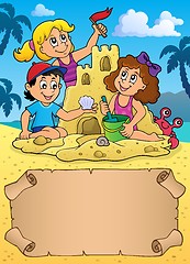 Image showing Small parchment and kids by sand castle