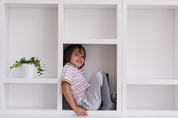 Image showing young boy posing on a shelf