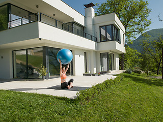 Image showing woman doing exercise with pilates ball