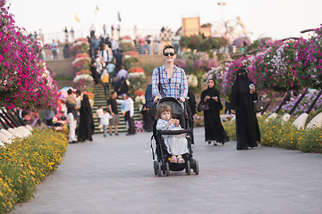 Image showing mother and daughter in flower garden