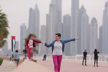 Image showing mother and cute little girl on the promenade