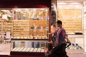 Image showing mother with  little girl in a stroller in front of  jewelry shop