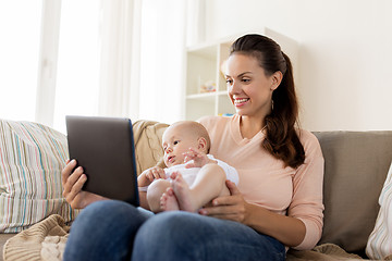 Image showing happy mother and baby boy with tablet pc at home