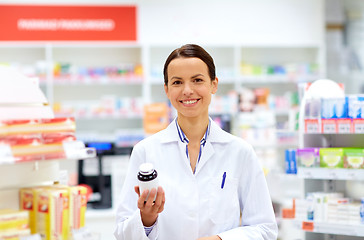 Image showing happy female apothecary with drug at pharmacy