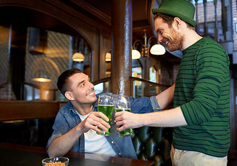 Image showing male friends drinking green beer at bar or pub