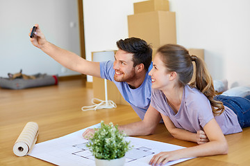 Image showing couple taking selfie and moving to new home