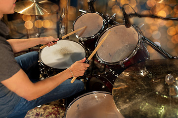 Image showing male musician playing drum kit at concert